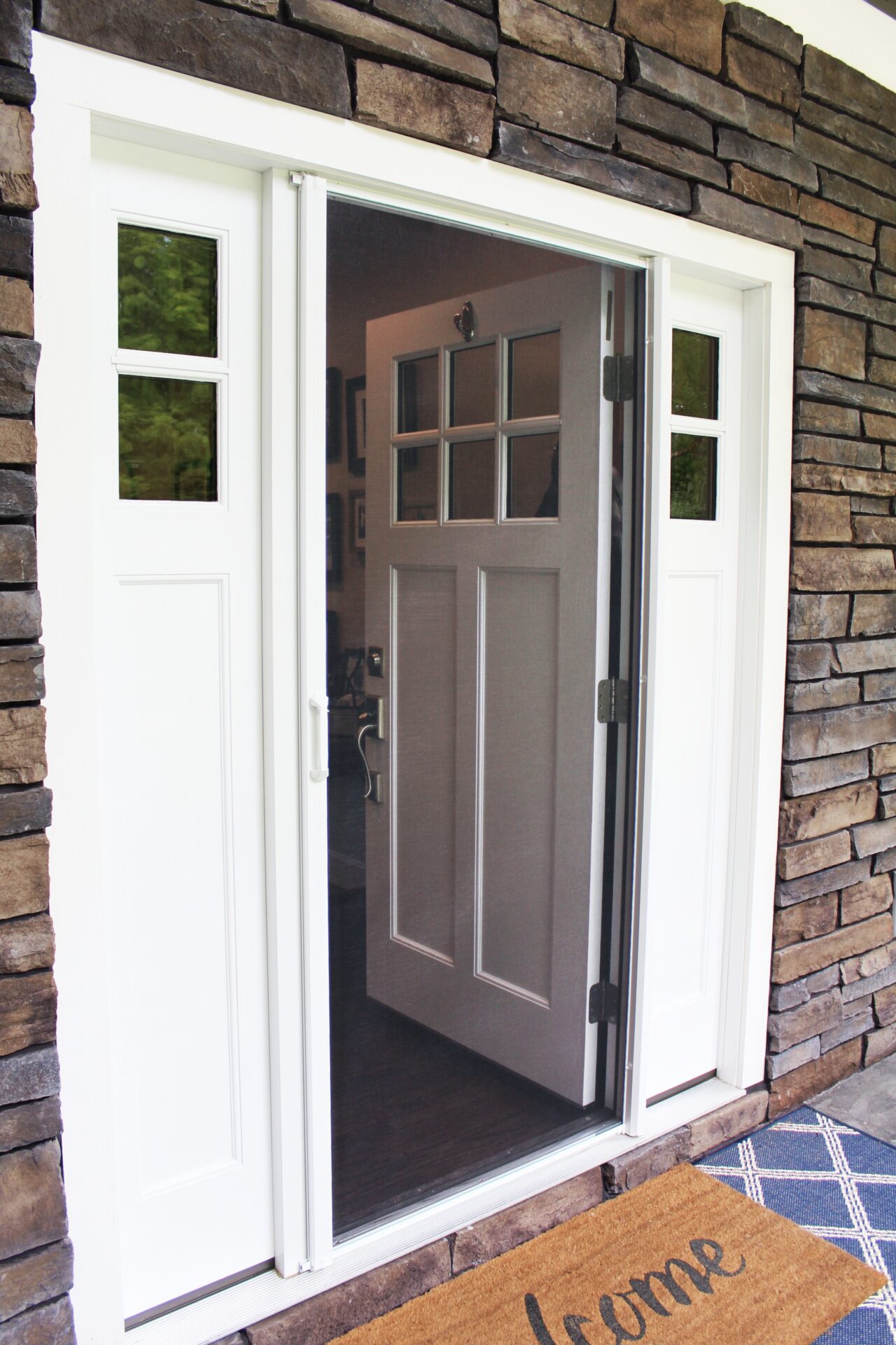 Screening Solutions Ohio uses a Phantom Retractable Screen Door on a white front door.