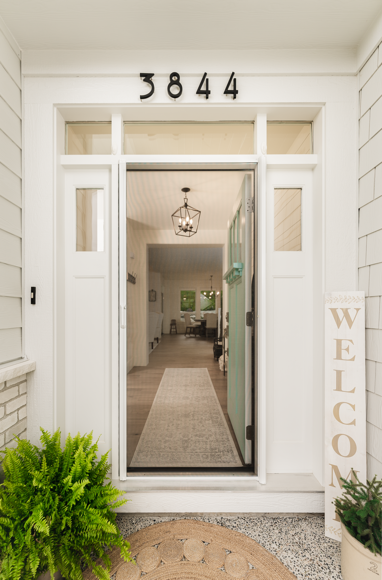 A Phantom Retractable Screen Door mounted to a white front door.