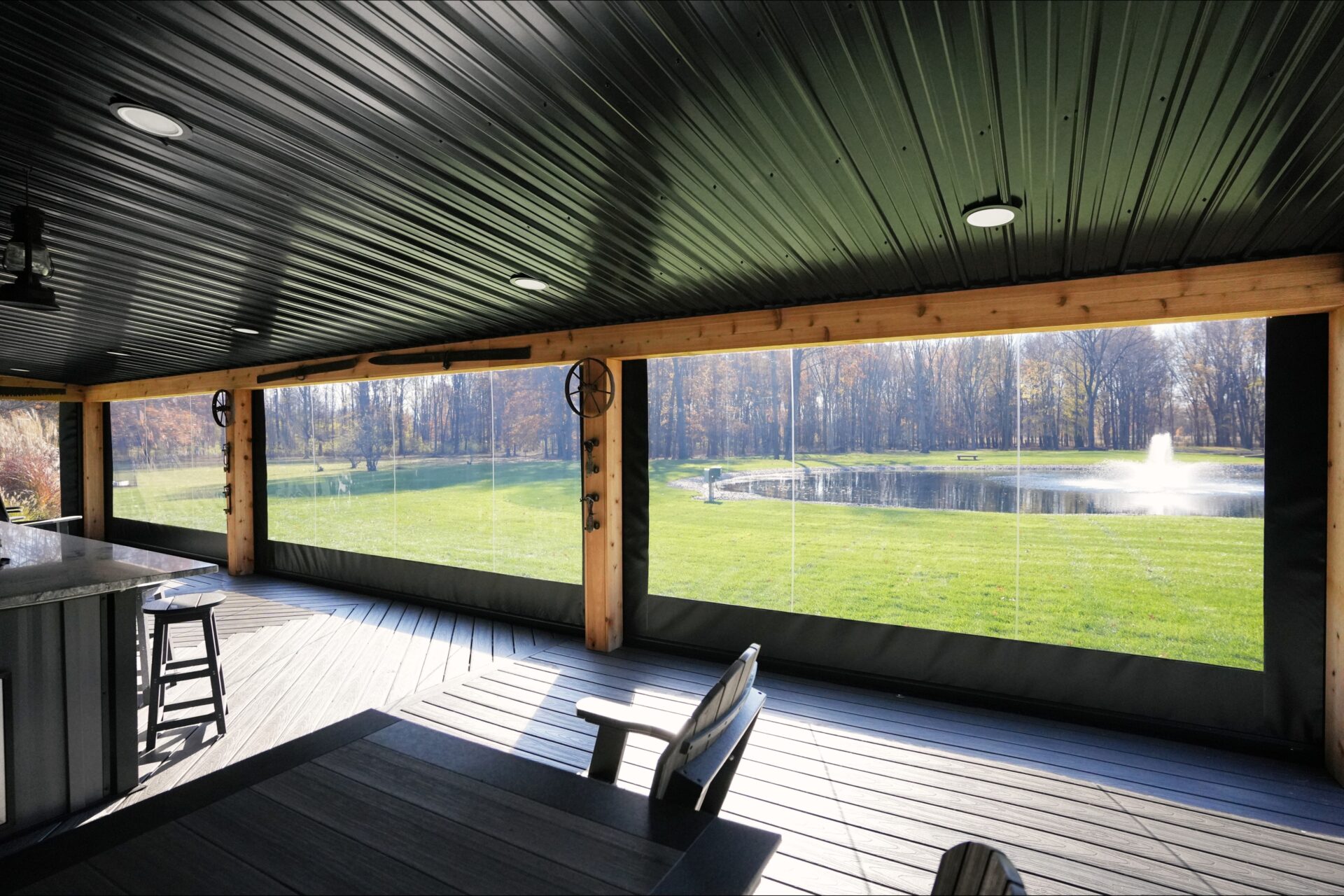 This back porch in Columbia Station, Ohio converts from an open outdoor space into a four-season room with Phantom’s Motorized Vinyl. Screening Solutions Ohio installed five large clear vinyl units to enclose this porch. The vinyl retains the heat in during the winter so the homeowner can enjoy their patio space year-round. The vinyl drops down sealing in the space and keeps out rain and snow.