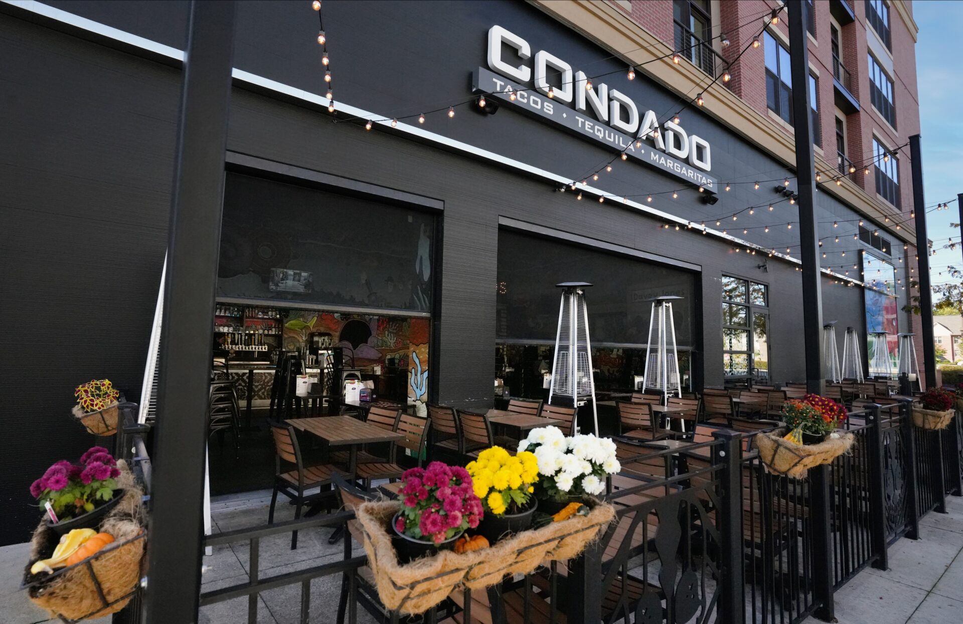 Condado Tacos is a popular local taco joint located right inside of Crocker Park. Screening Solutions Ohio installed Phantom Retractable Power Screens onto the restaurants two large garage openings. The motorized screens provide bug protection in a matter of seconds. With the touch of a button, the screens drop down and seal in the space. Whenever the screens aren’t needed, they roll up and hide away inside their protective housing units blending in with the look of the building.