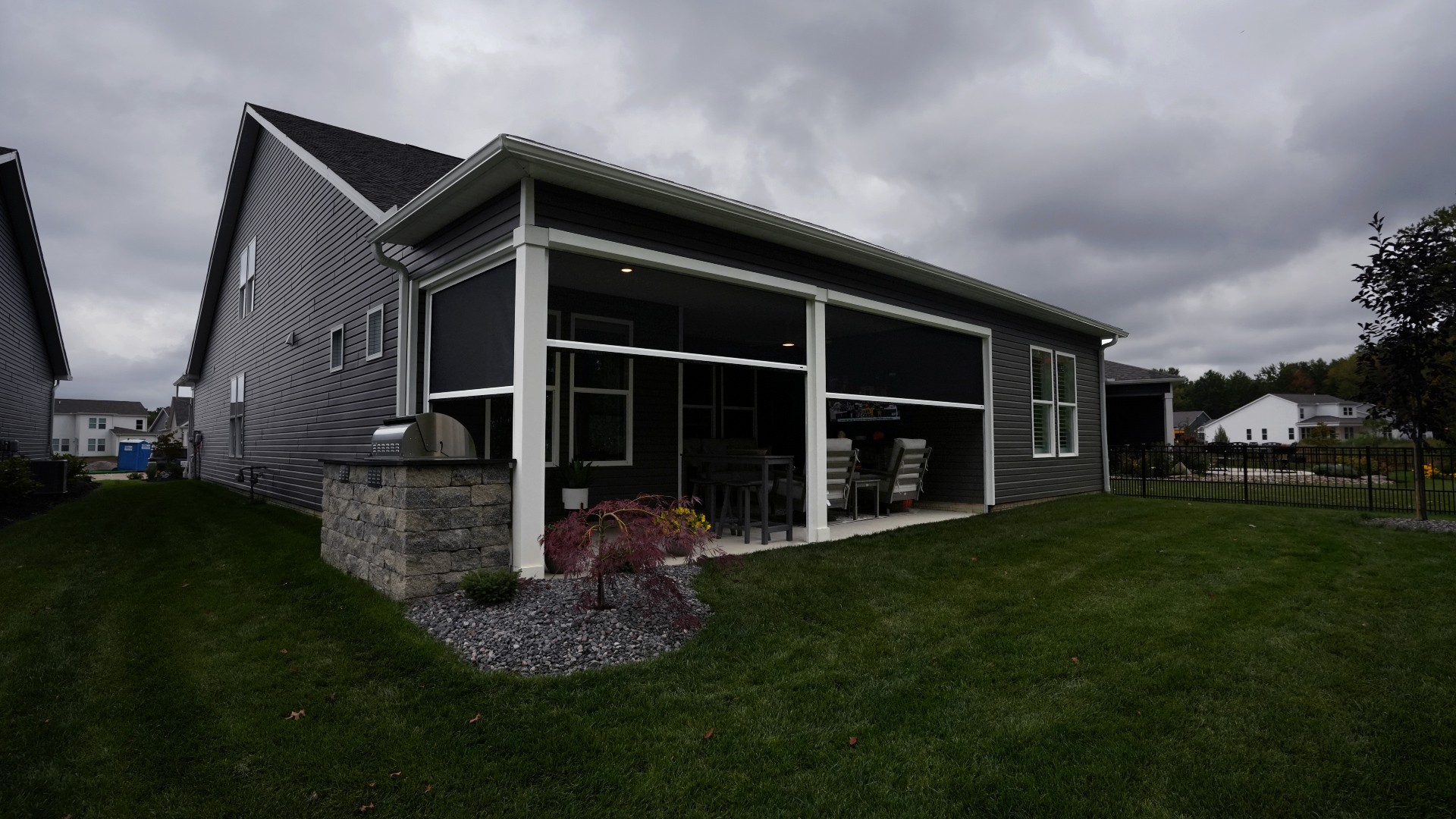 Christmyer Photo 1 The Screening Solutions installation team took this open covered patio in Avon Lake, Ohio and by adding three Phantom Motorized Retractable Screens to the patio’s openings, it’s now a bug-free and breezy outdoor sanctuary. The screens use an insect mesh to keep out bugs while still allowing fresh air to cool down the space and preserve the view out.