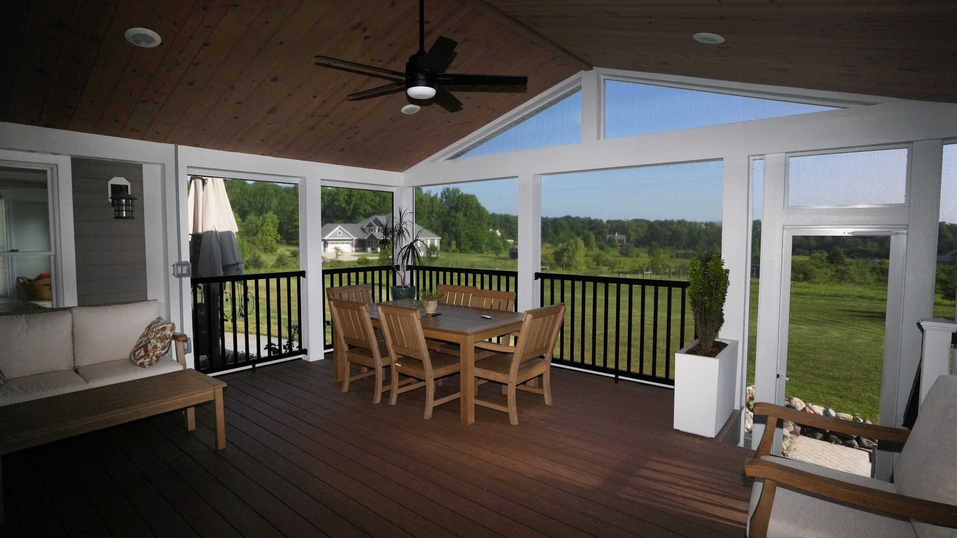 Screening Solutions transformed this covered patio in Brecksville by installing custom Phantom Motorized Screens to the main three openings and then used custom fixed screening for the uniquely shaped openings and peak.
