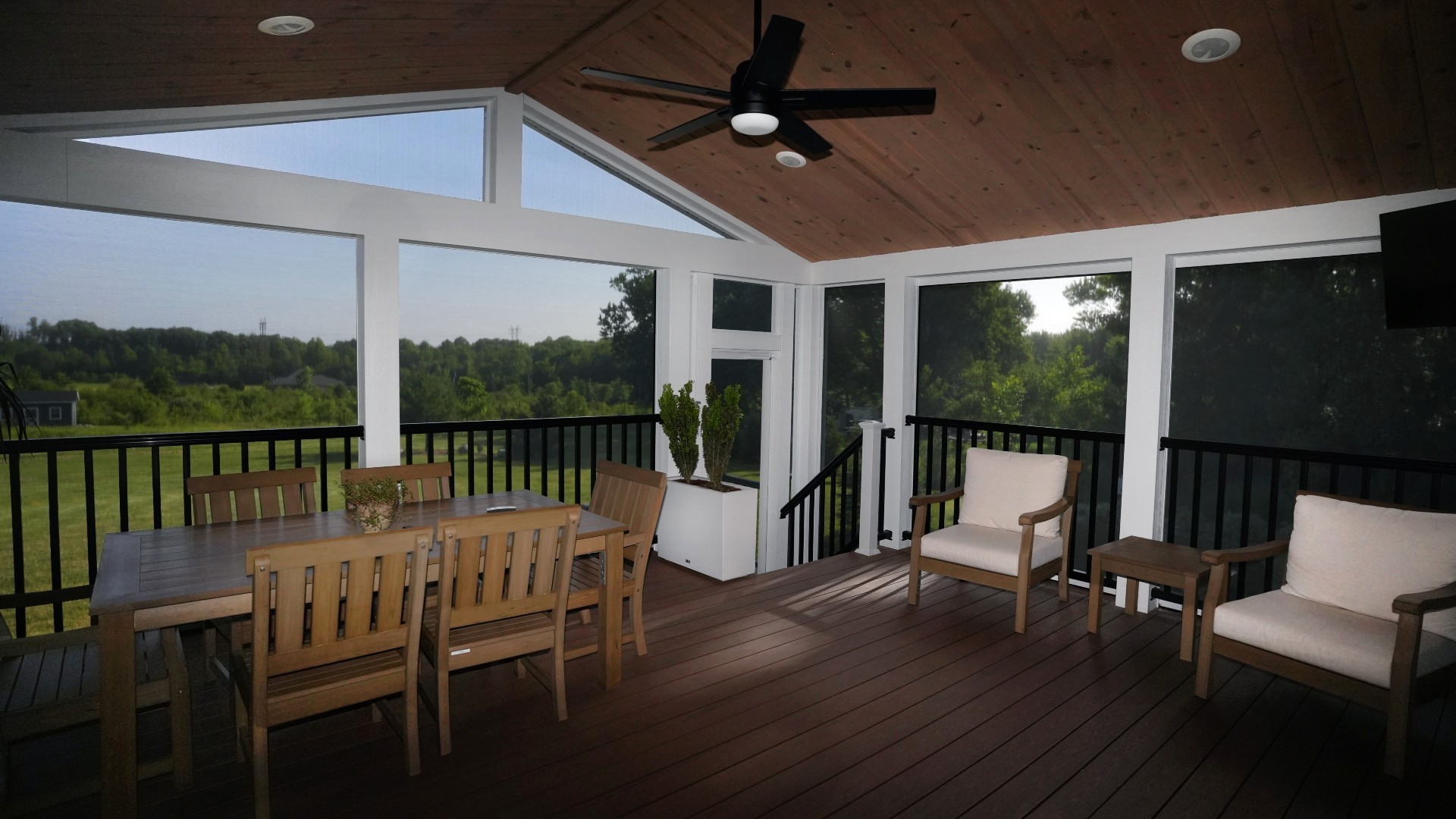 Screening Solutions transformed this covered patio in Brecksville by installing custom Phantom Motorized Screens to the main three openings and then used custom fixed screening for the uniquely shaped openings and peak.