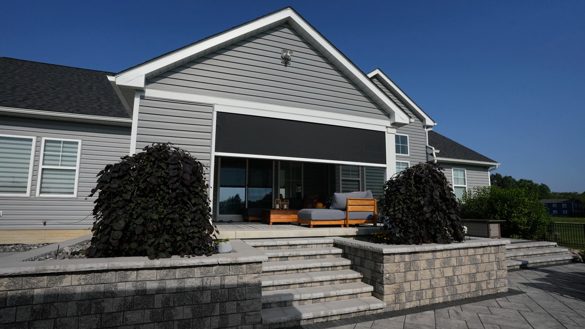 Phantom Retractable Power Screens with solar mesh on a home in Columbia Station, Ohio. These custom solar screens were installed by Screening Solutions and integrated into both the covered patio and the pergola space.