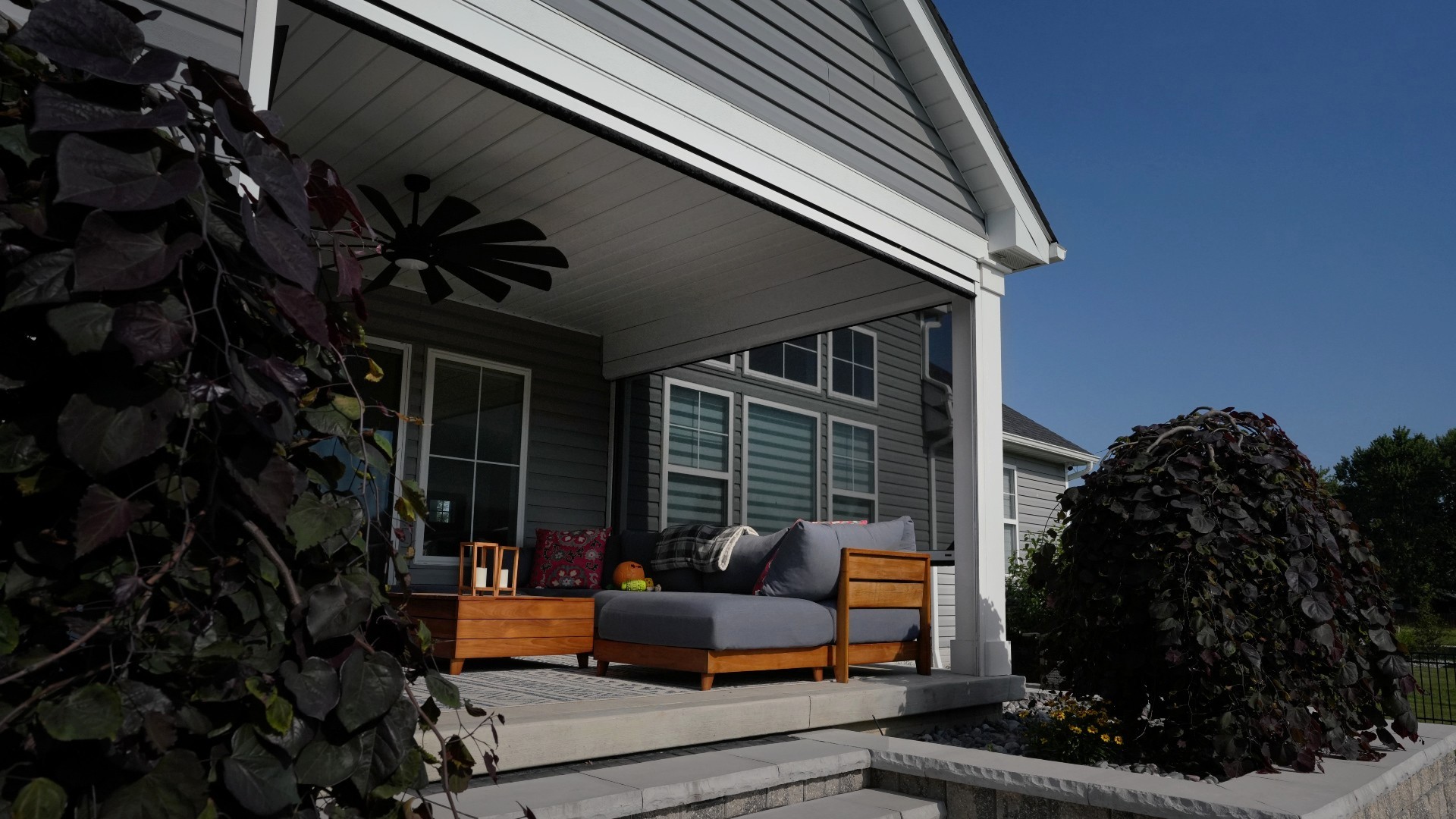 Phantom Retractable Power Screens with solar mesh on a home in Columbia Station, Ohio. These custom solar screens were installed by Screening Solutions and integrated into both the covered patio and the pergola space.
